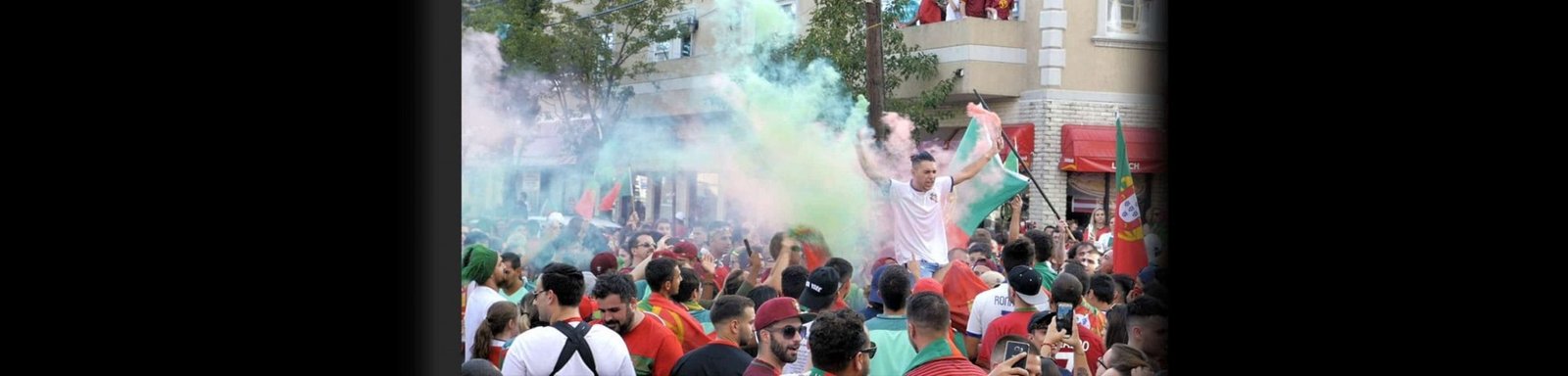 Portuguese soccer fan holding colored powders