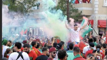 Portuguese soccer fan holding colored powders