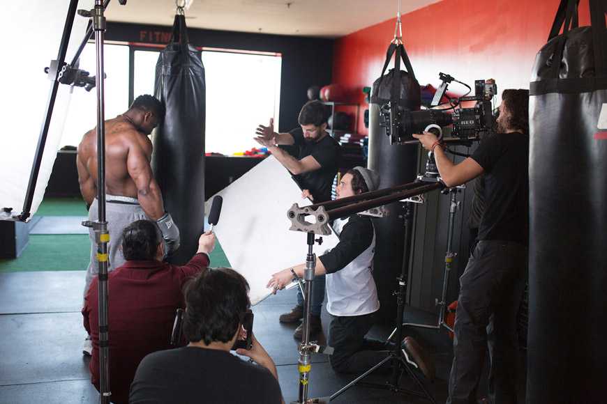 Robert Wilmote working out surrounded by and being filmed by film crew