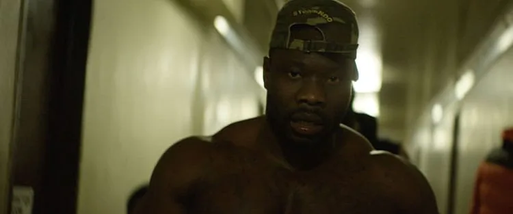 Robert Wilmote with cap walking down hallway