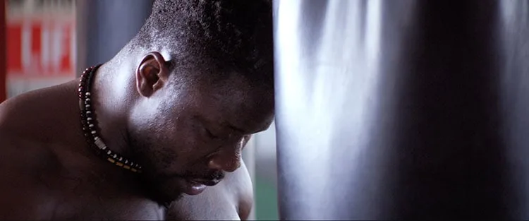 Robert Wilmote leaning against punching bag