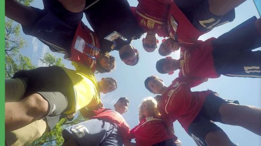 Ironbound Soccer Club in a group huddle