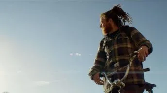 Tommy Cuba on a bike with blue sky