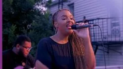 Daria Jones singing with mic in her hand