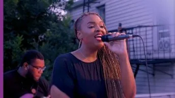 Daria Jones singing with mic in her hand