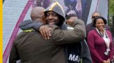 wyclef jean hugging a man, wyclef mural, wyclef, newark, upgraded, ras baraka
