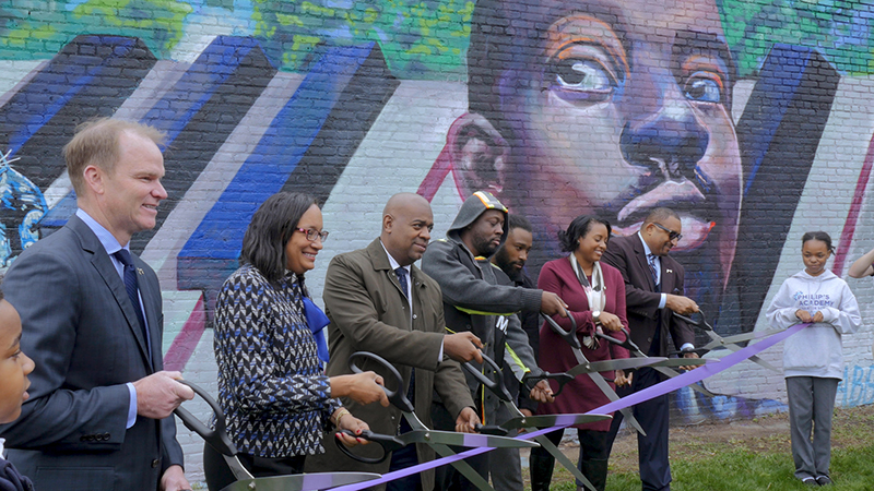 Newark Mayor Ras J. Baraka and Wyclef Jean cut the ribbon on Camille Coté's new mural, along with Hugh Weber (Harris Blitzer Sports), Vivian Cox Frasier (ULEC), Shané Harris (Prudential) and Jeremy Johnson (Newark Arts)