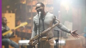 Josue Simon singing Brick City Blues, Winner and Peer Pressure while holding saxophone