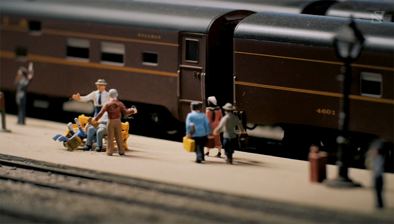 Little figurines in front of figure train